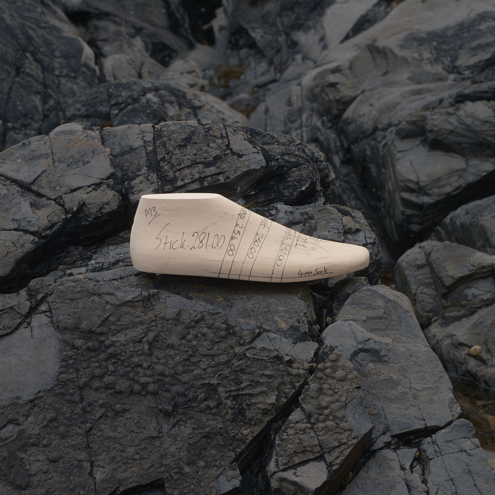 1812 hand made wooden last on rocks describing Glossary of Footwear Terms