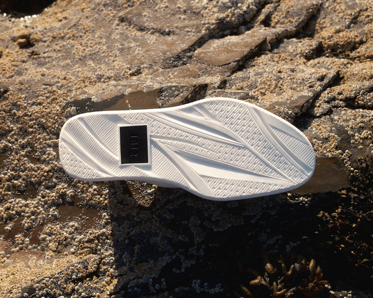 1812 HANDMADE RUBBER T-CAB SOLE, ON THE ROCKS THAT INSPIRED IT. MADE IN ENGLAND.